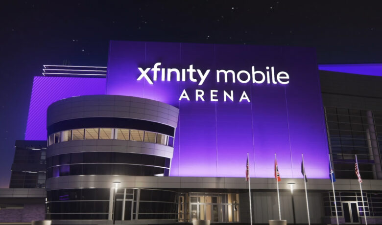An artist's rendering of the Xfinity Mobile Arena signage over one of the building's entrances at night.